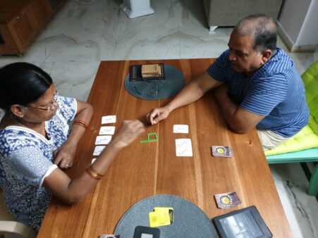 Parents of my dear friend Preethi are seen playing the card game “Slick Stick” gifted to them by her
